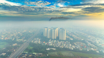 Fototapeta na wymiar Aerial view of Saigon cityscape at morning with misty sky in Southern Vietnam. Urban development texture, transport infrastructure and green parks