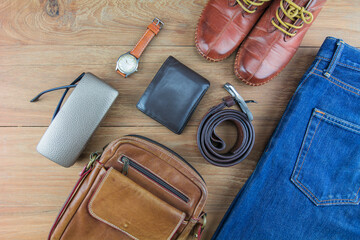 Leather for men on wooden background./ Flat lay leather for men./ Leather and jeans for men.