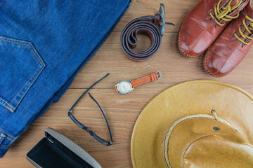 Leather for men on wooden background./ Flat lay leather for men./ Leather and jeans for men.