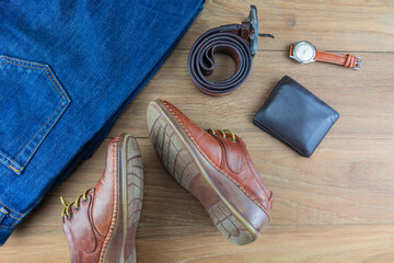 Leather for men on wooden background./ Flat lay leather for men./ Leather and jeans for men.