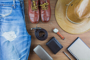 Leather for men on wooden background./ Flat lay leather for men./ Leather and jeans for men.