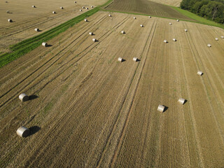 Aerial view of a field with hay bales in the countryside