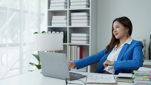 Attractive Asian businesswoman Relax from work after sitting for a long time. in order not to exceed the office syndrome at the office.