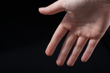 Five  fingers of a human hand partly seen in view