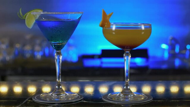 Two pair of colorful drinks cocktail in cup glass fancy night club , fruite slice friendship celebrative party atmosphere 