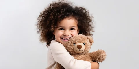 Fotobehang child hugs a bear doll on a white background, generative AI © VALUEINVESTOR