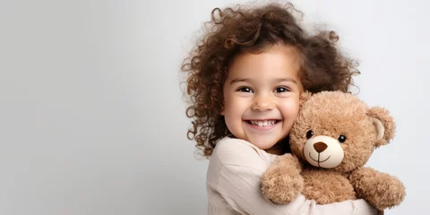 Fotobehang child hugs a bear doll on a white background, generative AI © VALUEINVESTOR
