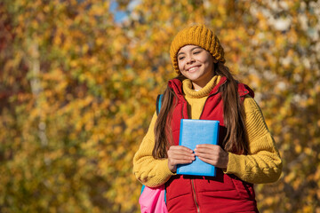 happy teen child back to school in autumn. copy space