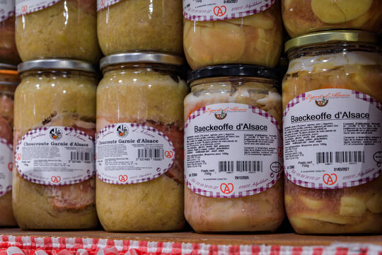 Strasbourg, France - May 31, 2023: Traditional Alsatian baeckeoffe or baker's oven stew made with Riesling in glass jars, display at a souvenir store