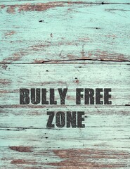 Blue old wood wall copy space background with text BULLY-FREE ZONE, anti bully policy , stop or...