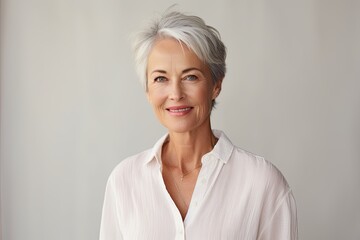 Senior woman portrait, mature grey haired beautiful smiling lady with light background, studio shooting - obrazy, fototapety, plakaty