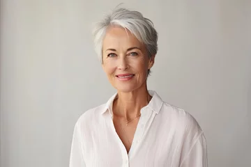 Foto op Plexiglas Senior woman portrait, mature grey haired beautiful smiling lady with light background, studio shooting © leftmade