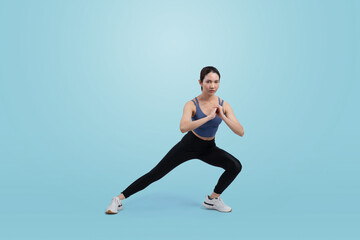 Fototapeta na wymiar Young attractive asian woman in sportswear stretching before fitness exercise routine. Healthy body care workout with athletic woman warming up on studio shot isolated background. Vigorous
