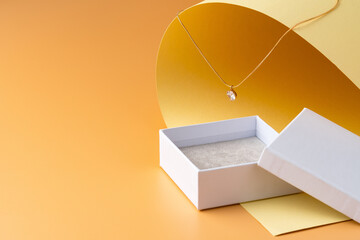 White jewelry box on yellow studio background