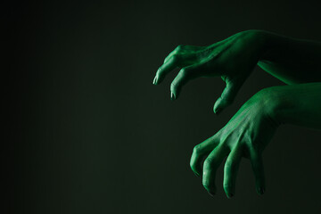 Green female hands on green background, space for text