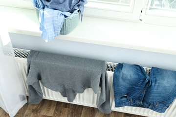 Clothes are dried on the radiator after washing