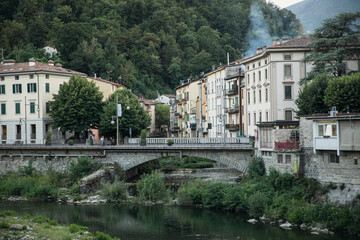 Fototapeta na wymiar Porretta, Italy 2023. View of a old tourist town located in the mountains, near the river with bridge. Touristic concept.