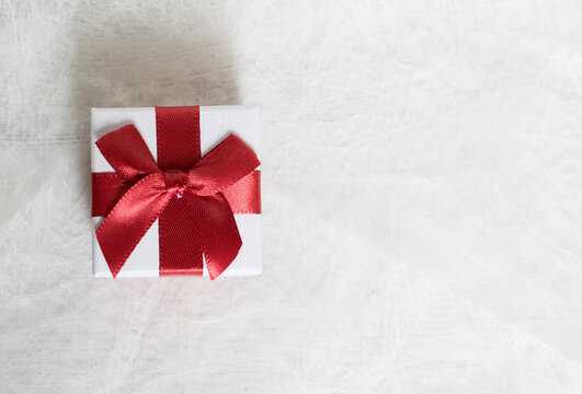 gift box with red bow on a white background and space to work

