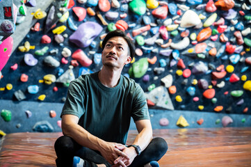 Portrait of a young Asian man at bouldering gym