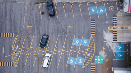 aerial view of a parking lot with many spaces for disabled people cars