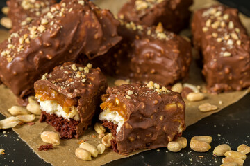 Chocolate sticks with peanuts on a dark background
