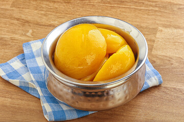 Sweet canned peaches with syrope
