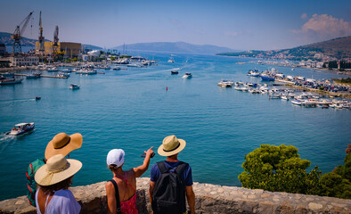 people in hats on the observation deck admire the landscape of Trogir - obrazy, fototapety, plakaty