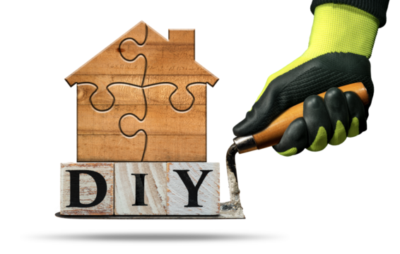 Gloved hand holding a dirty trowel and the DIY text (do it yourself), made of wooden blocks and a small wooden house formed from jigsaw puzzle pieces. Isolated on white or transparent background. Png. - Powered by Adobe