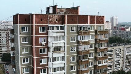 Top view of old residential buildings in city in summer. Stock footage. Residential communal complexes in old district of city. Shabby old houses in residential area in summer