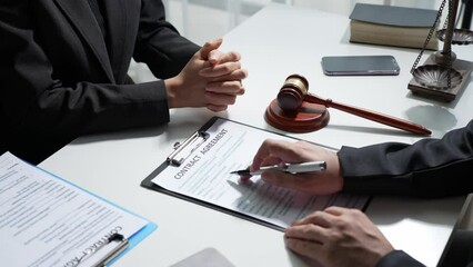 The lawyer working with a client discussing contract paper, a Business lawyer working about legal legislation in the courtroom to help their customer