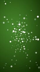 Snowy christmas background. Subtle flying snow flakes and stars on christmas green background. Delicate sweet snowy christmas. Vertical vector illustration.
