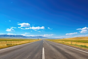 empty road stretching ahead under a blue sky