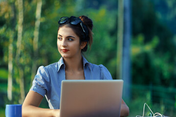 Amidst greenery, woman balances work and serenity