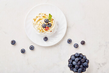 Top view of Pavlova Dessert with blueberry. Autumn aesthetics vibes background. Cozy home table setting