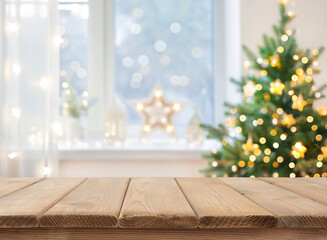 Empty table in front of christmas tree with decoration background