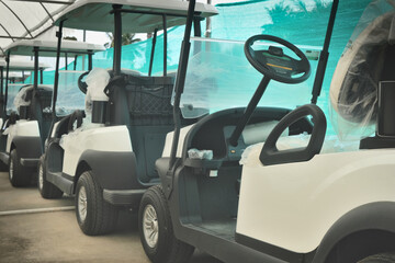 Close up shot of golf cart parked in rows