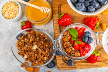 Granola bowl. Yogurt with oatmeal, fresh berries, spirulina and chia seeds. Healthly food. Tasty breakfast. Yogurt with strawberries, raspberries, blueberries, peaches, mint and mendal. Copy space.