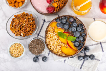 Granola bowl. Yogurt with oatmeal, fresh berries, spirulina and chia seeds. Healthly food. Tasty breakfast. Yogurt with strawberries, raspberries, blueberries, peaches, mint and mendal. Copy space.