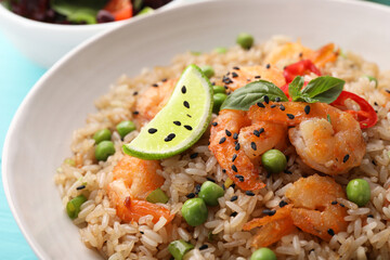 Tasty rice with shrimps and vegetables in bowl, closeup