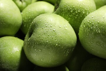 Fresh green apples with water drops as background, closeup