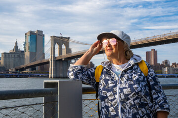 Elderly Woman Strolling Through New York with a Stunning Manhattan View