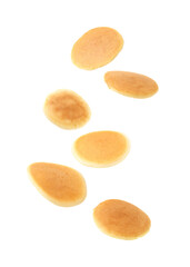 Many tasty fresh pancakes falling on white background
