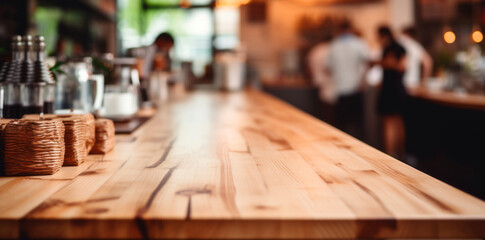 Top of wooden table on blur background with lights of bar, cafe, coffee shop or restaurant and barista . Using for mock up template for display of your design