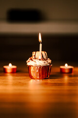 Delicious cupcake with candle and copper paper. Celebrating diversity and joy