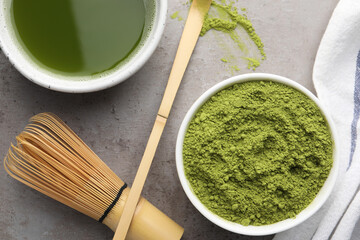 Flat lay composition with green matcha powder and fresh beverage on light grey table