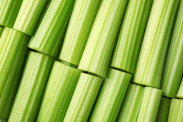 Fresh green cut celery as background, top view