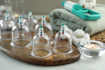 Many plastic cups on white table. Cupping therapy