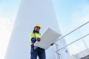 Technician engineer African man worker builders looking for wind turbine blueprint drawings for...