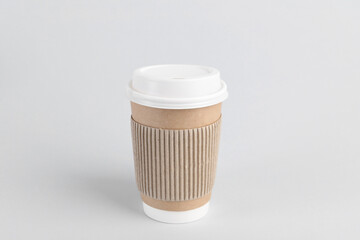 Paper cup with plastic lid on light background. Coffee to go