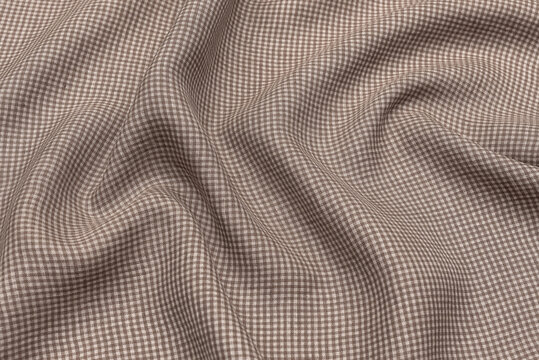 Classic linen brown fabric textured background. Expensive men's suit fabric.Check is made of linen fabric with a woven twill design of small checks. Houndstooth seamles